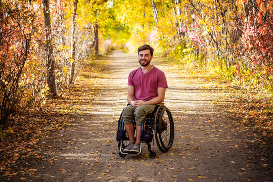 Portrait of a paraplegic man in a wheelchair outdoors in a park in autumn; Edmonton, Alberta, Canada