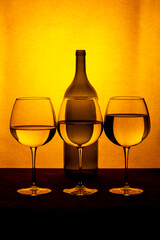 Still life with a wine bottle and glasses with liquid