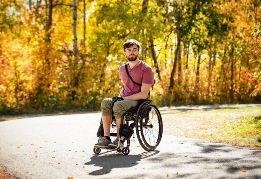Portrait of a paraplegic man in a wheelchair outdoors in a park in autumn; Edmonton, Alberta, Canada