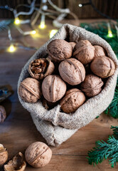 festive christmas nuts tumbling from a burlap bag