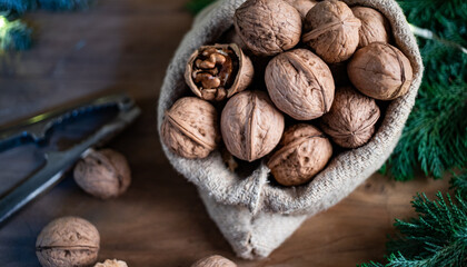 festive christmas nuts tumbling from a burlap bag