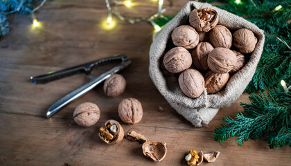 festive christmas nuts tumbling from a burlap bag