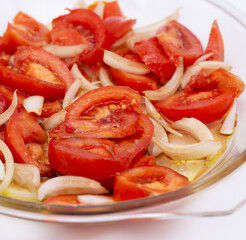 A simple tomato salad ready to eat with a white background, Braga, Portugal.
