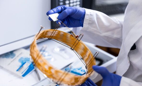 Researcher carrying out scientific research in a lab (shallow DOF; color toned image)