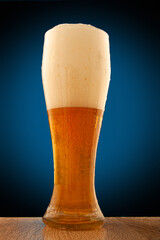 foam and bubbles in a beer glass close-ups on a blue background.