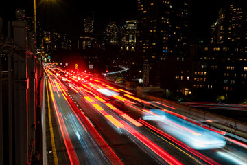 Traffic in a big metropolis. Traffic jam over the Brooklyn Bridge. The movement of cars in the night city.
