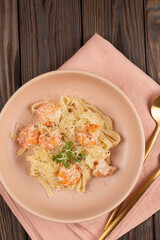 Pasta al dente with shrimp in cream sauce with cheese, open space