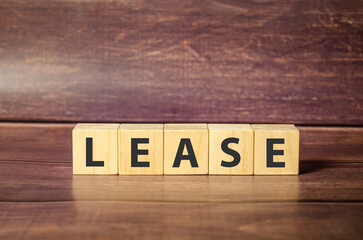 LEASE word on wood blocks concept with brown background