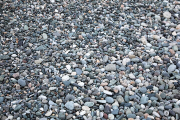 Surface covered with many different pebbles as background