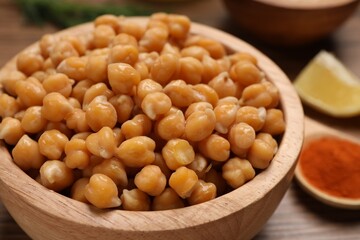 Delicious chickpeas on wooden table, closeup. Hummus ingredient