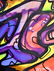 Colorful background of graffiti painting artwork with bright aerosol strips and beautiful colors. Old school street art piece made with aerosol spray paint cans. Contemporary youth culture backdrop