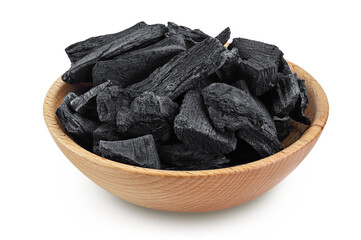 Natural charcoal in wooden bowl isolated on white background with full depth of field