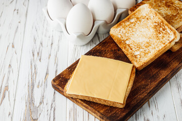 delicious cheese sandwich on a white rustic wooden background
