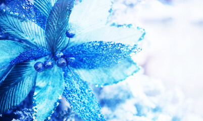 New Year's decor. Bright christmas background, copy space. Decorative decoration from Christmas blue flowers, soft focus, toned 
