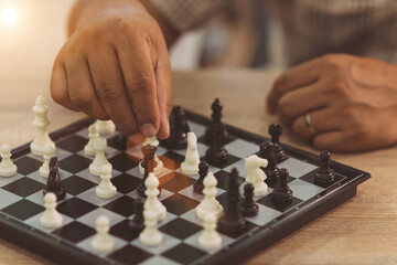 business person play chess game. office people have a break by test brian using puzzle board train in free time. smart employee practice intelligence match chess board in a break desk at workplace