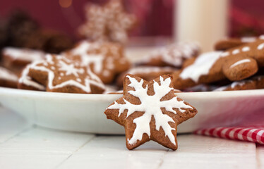 Spicy ginger cookies in a star-shaped glaze, milk and many cookies on a plate. Winter New Year's pastries, background