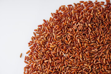 raw fresh red rice on a white background