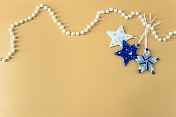 New Year blue stars with white beads on beige background