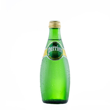 A bottle with water droplets of carbonated natural mineral water Perrier, enriched with gas from the source.
