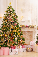 A large beautiful traditional Christmas tree with gifts in a classic interior.