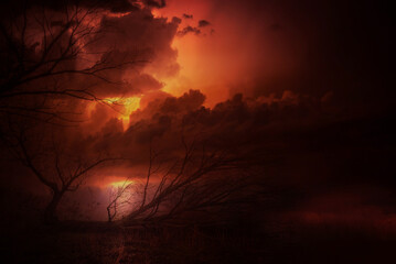 Dark landscape showing forest and storm sky at autumn night