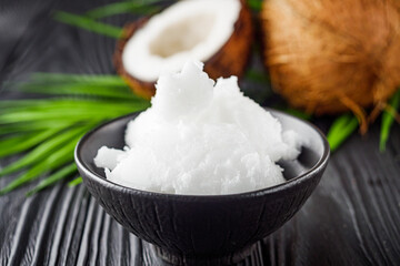 fresh natural coconut butter on black wooden background