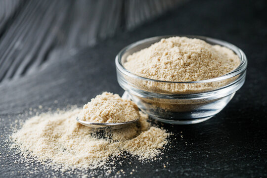asafoetida aromatic powder on a black stone background