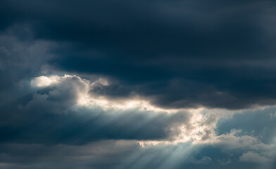 Fototapeta premium Beautiful nature background. Rays of sunlight through the clouds.