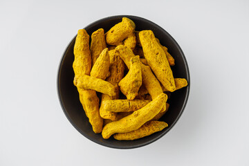aromatic turmeric root on a white acrylic background