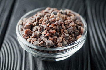 crystalline black Himalayan salt on a black wooden background
