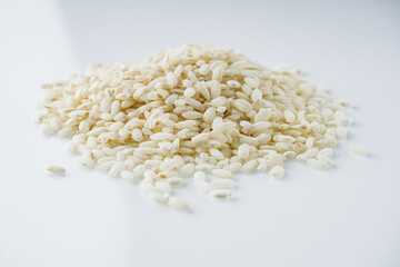 arborio rice for risotto on a white acrylic background