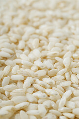 arborio rice for risotto on a white acrylic background