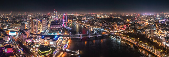 Naklejka na ściany i meble Epic night aerial view of the London, River Thames, London Eye, Westminster. Panorama cityscape
