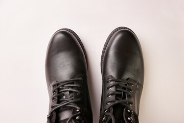 Black leather men's boots on a white background. Warm shoes for winter.