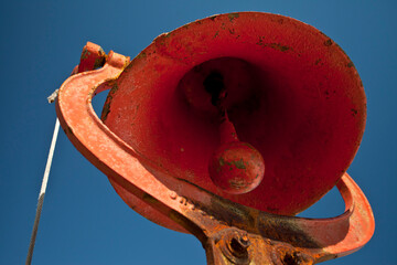 Red dinner bell against blue sky
