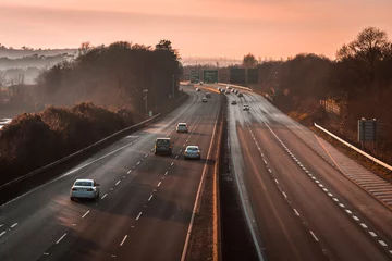 Foto op Plexiglas A sunset view on a motorway In Ireland Cork © Cristi