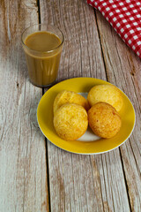 Traditional Brazilian breakfast, cheese bread, and coffee with milk. Selective focus. Top view 