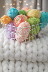 Cozy homely atmosphere. Female hobby knitting. Yarn pastel multicolor in a basket. 