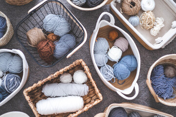 Many baskets made of natural eco-friendly materials. Yarn for knitting, knitting needles
