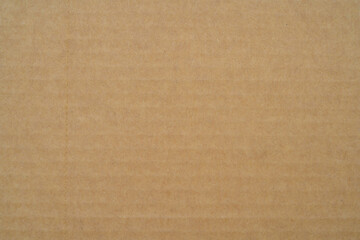 smooth brown cardboard paper, full frame, close up. background and texture of brown paper corrugated sheet board surface