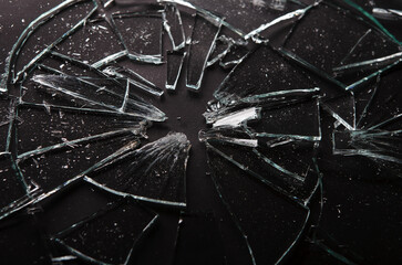 Close up of broken glass on dark background with lots of splinters