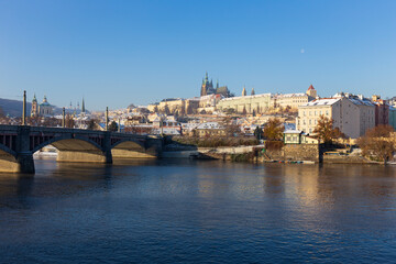 Obraz premium Snowy Prague Lesser Town with Prague Castle above River Vltava in the sunny Day , Czech republic