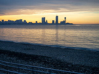 View of the sea modern city. Batumi from afar. Tall houses on the sea. Beautiful landscape.  Batumi at sunset