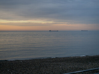 Seascape. Barges on the horizon. Dry cargo ships at sea. Black Sea at sunset.