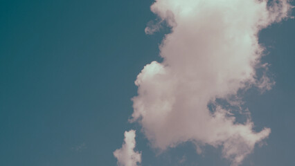 A big vertical white cloud in a single cluster in a clear sky. Cloud cluster can be used for graphic works and resource