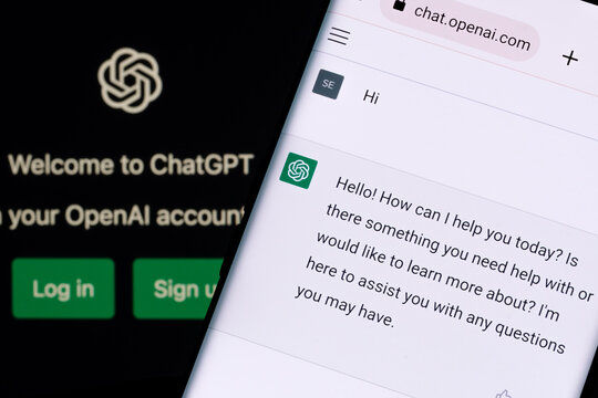 ChatGPT chat bot screen seen on smartphone and laptop display with Chat GPT login screen on the background. A new AI chatbot by OpenAI. Stafford, United Kingdom, December 13, 2022.