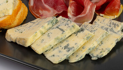 Prosciutto Tapas and Mold Cheese on Black Plate, Spanish Jamon Slices, Parma Ham, Sliced Serrano, Iberico