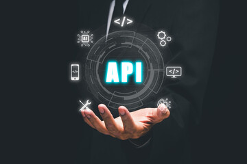 API - Application Programming Interface, Man hand holding VR screen API icon on office desk, Software development tool, modern technology, internet and networking concept