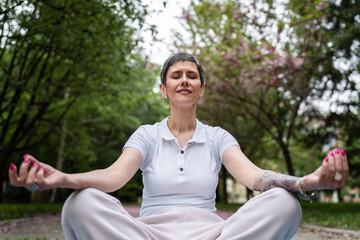 one mature woman senior female meditate alone in park in day