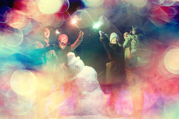 group of friends with snowman sparklers party, christmas night and happy new year